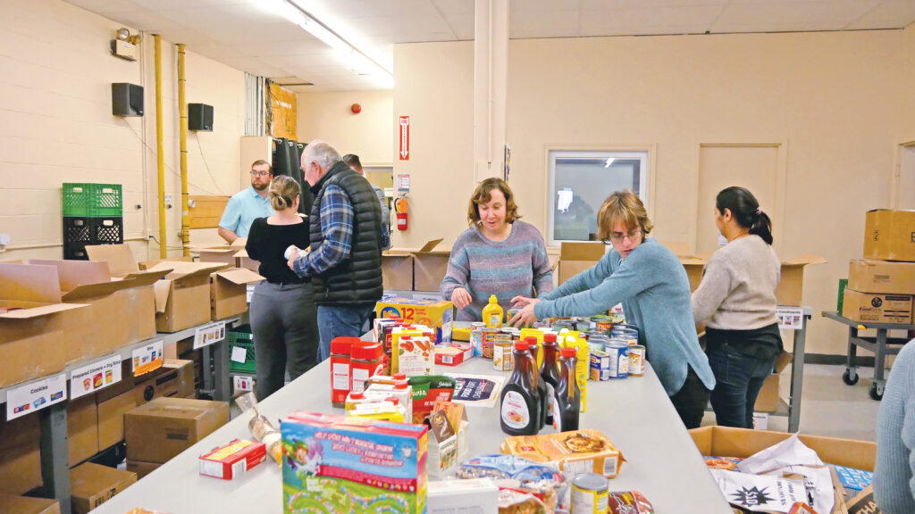 Paquette Travers team unloading and sorting non-perishable food.
