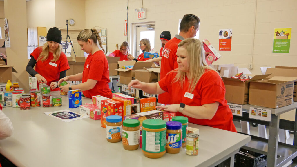 Peak Realty team sorting non-perishable food.