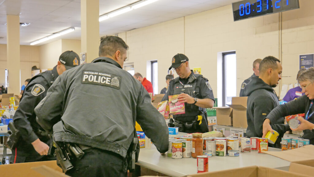 Waterloo Region Police Services unloading and sorting non-perishable food.