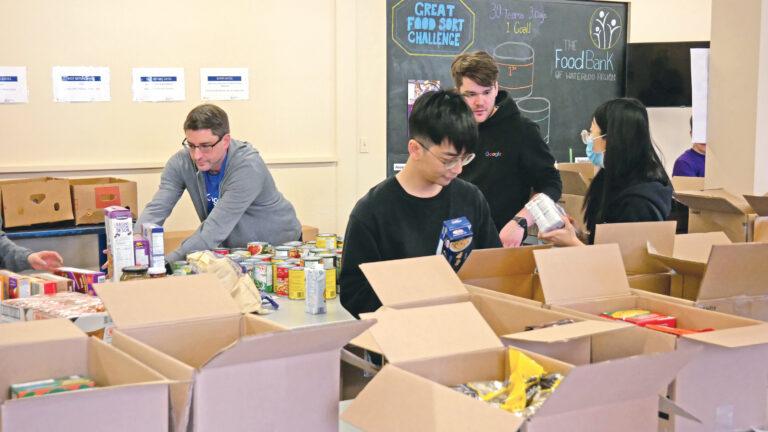 Google team unloading and sorting non-perishable food.