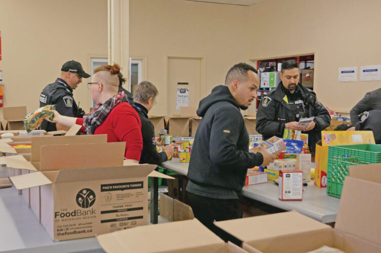 Waterloo Region Police Services sorting non-perishable food.