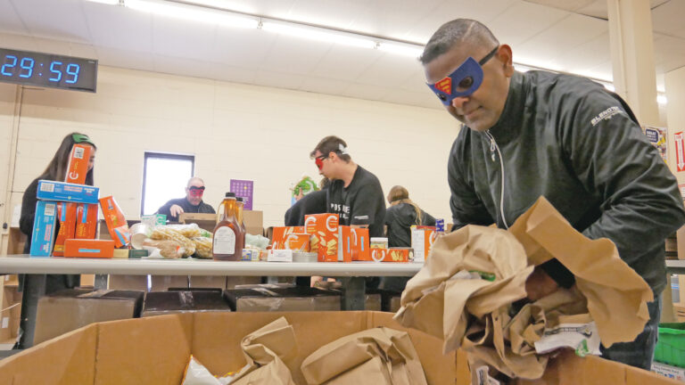 Blendtek team 1 unloading and sorting non-perishable food.