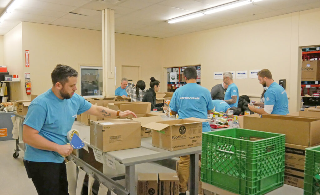 Volkswagen Waterloo team sorting and taping boxes of non-perishable food.
