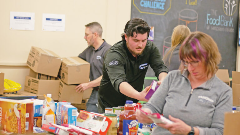 Parkway Ford team unloading and sorting non-perishable food.