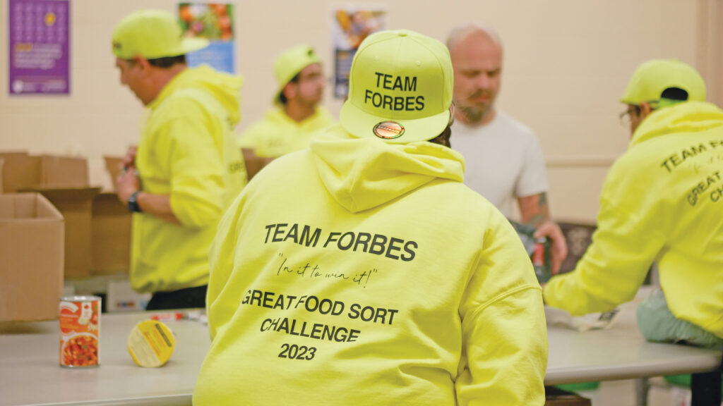 Forbes Motors team unloading and sorting non-perishable food.