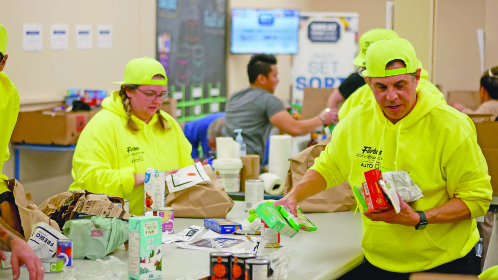Forbes Motors team unloading and sorting non-perishable food.