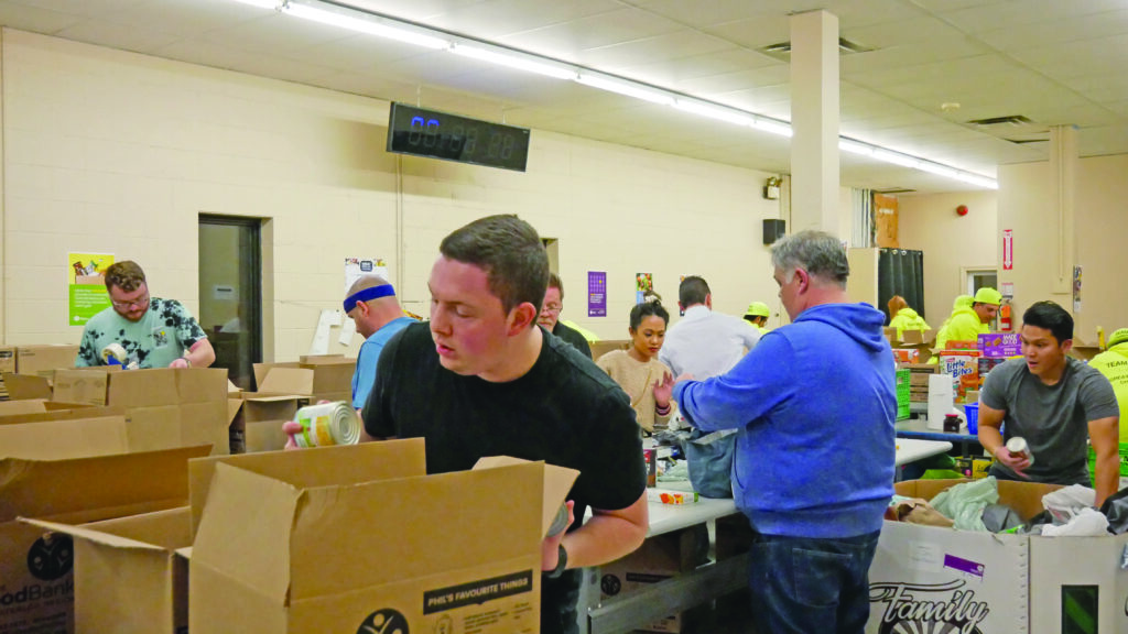 Kitchener Hyundai team unloading and sorting non-perishable food.