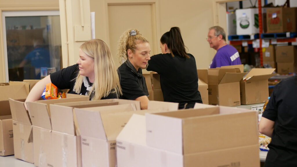 Movati Athletics team sorting non-perishable food.