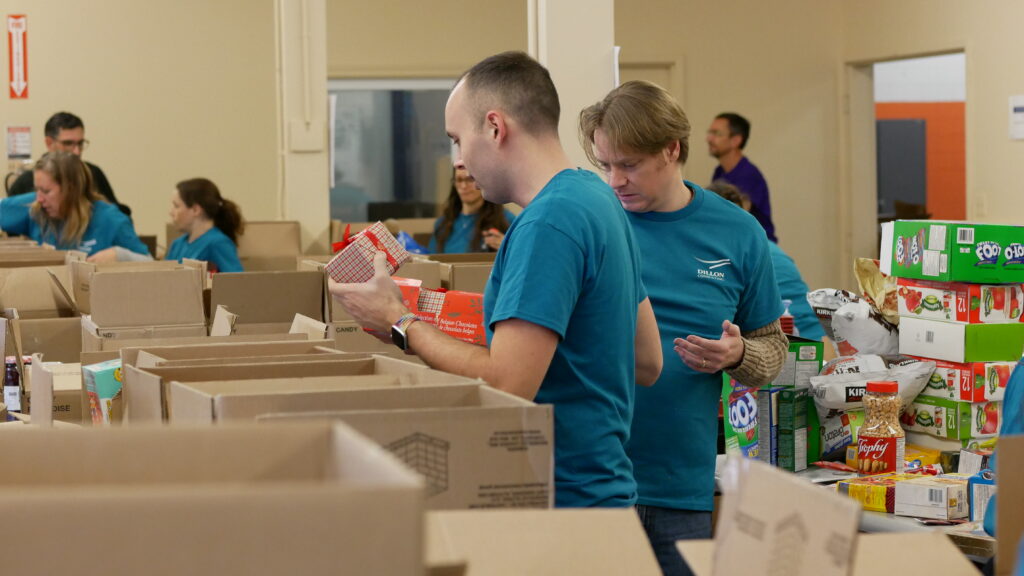 Dillon Consulting team 1 members sorting non-perishable food.