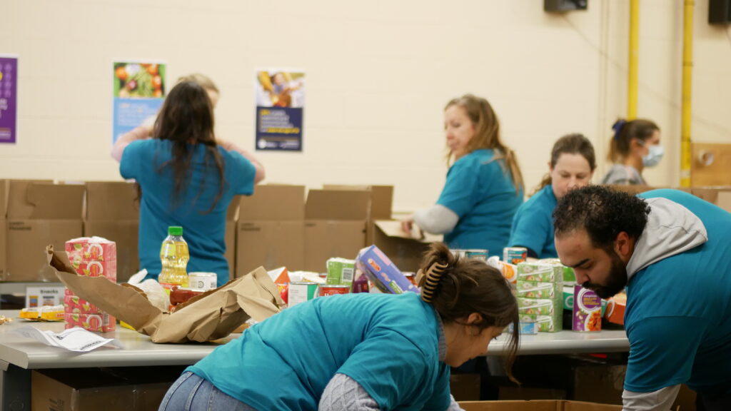 Dillon Consulting team 2 unloading and sorting non-perishable food.