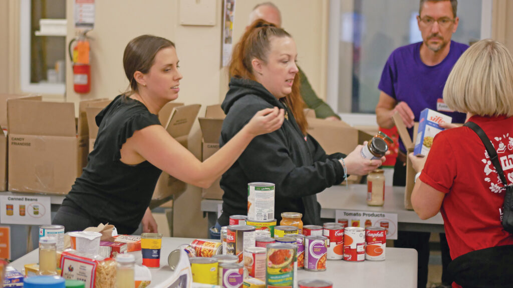Robert Half team sorting non-perishable food.