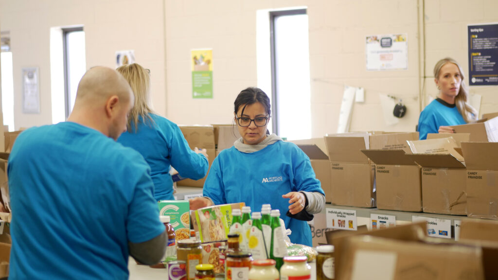 Bennet Capital team unloading and sorting non-perishable food.