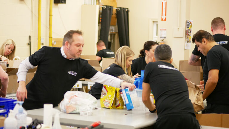 Kitchener Ford team unloading and sorting non-perishable food.