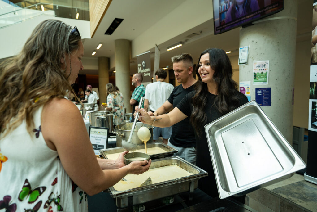 Empty Bowls 2023 - Person serving soup to an event participant