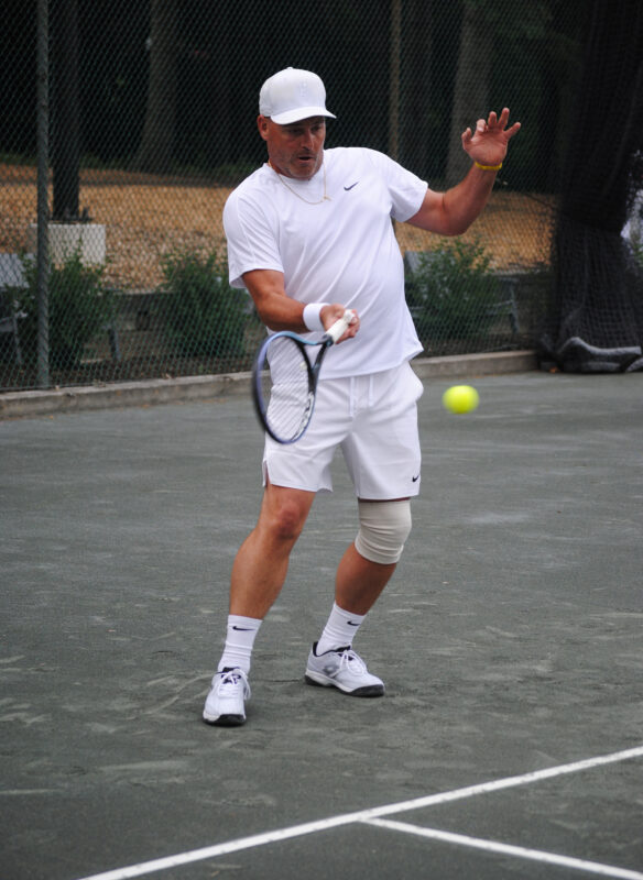Man hitting a tennis ball.