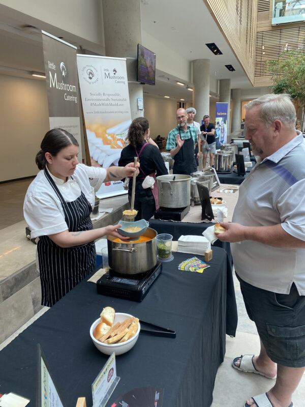 Empty Bowls 2023 - Chef serving food to a person.