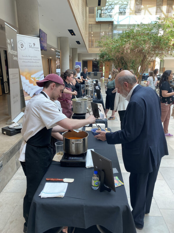 Empty Bowls 2023 - Chef serving soup to a person