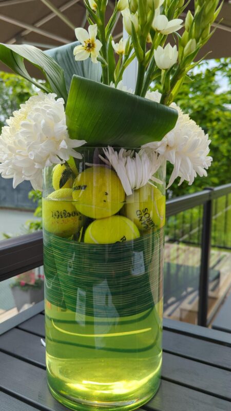 Vase with tennis balls inside