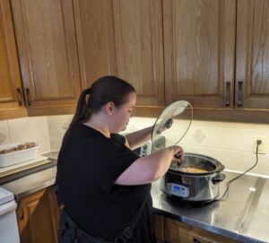 A staff member prepares a meal for residents.