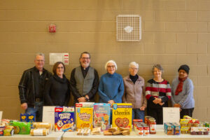 Ron Bender, Jane Bender, Marty Levesque, Rachel Prichard, and others who help coordinate the food hamper program are pictured here.