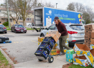 Jordan Wettlaufer accepting a delivery from The Food Bank.