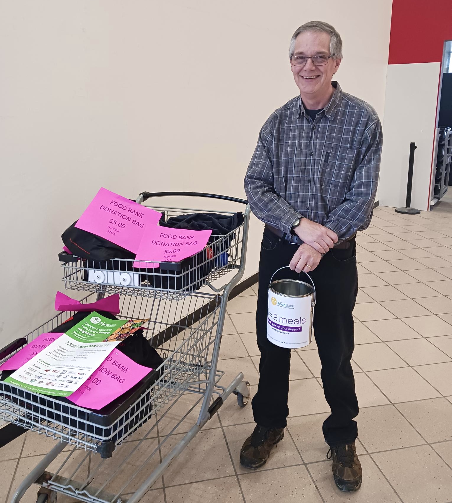 John collecting donations at a grocery store.