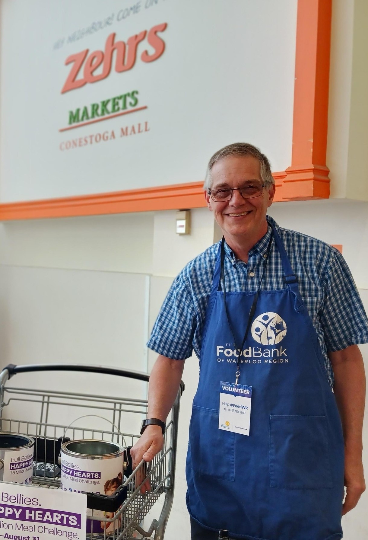 John collecting donations at a grocery store.