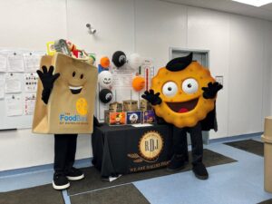 RDJ Bakeries’ mascot, Munchie, is pictured with The Food Bank’s mascot, Phil the Food Drive Bag.
