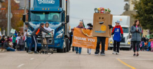 The Food Bank mascot walking with others in the parade.