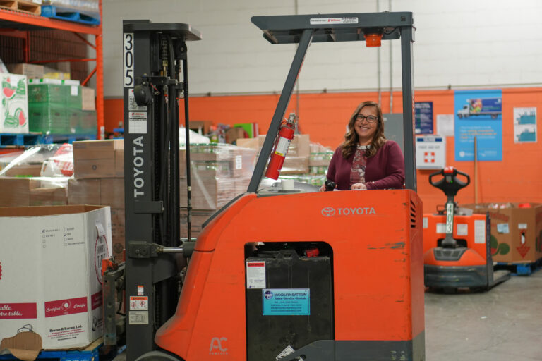 Lydia Tavares operating a forklift.