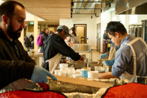 Staff and volunteers serving meals at St. John’s Kitchen.