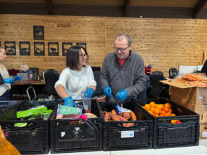 Staff and volunteers packing food hampers.