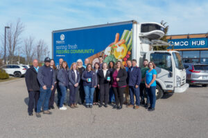 The MCC Ontario team with The Food Bank team standing infront of the Food Bank of Waterloo region's truck.