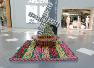 Windmill in a field of flowers created using various canned and boxed products as well as tea bags. This sculpture was featured in Conestoga Mall.