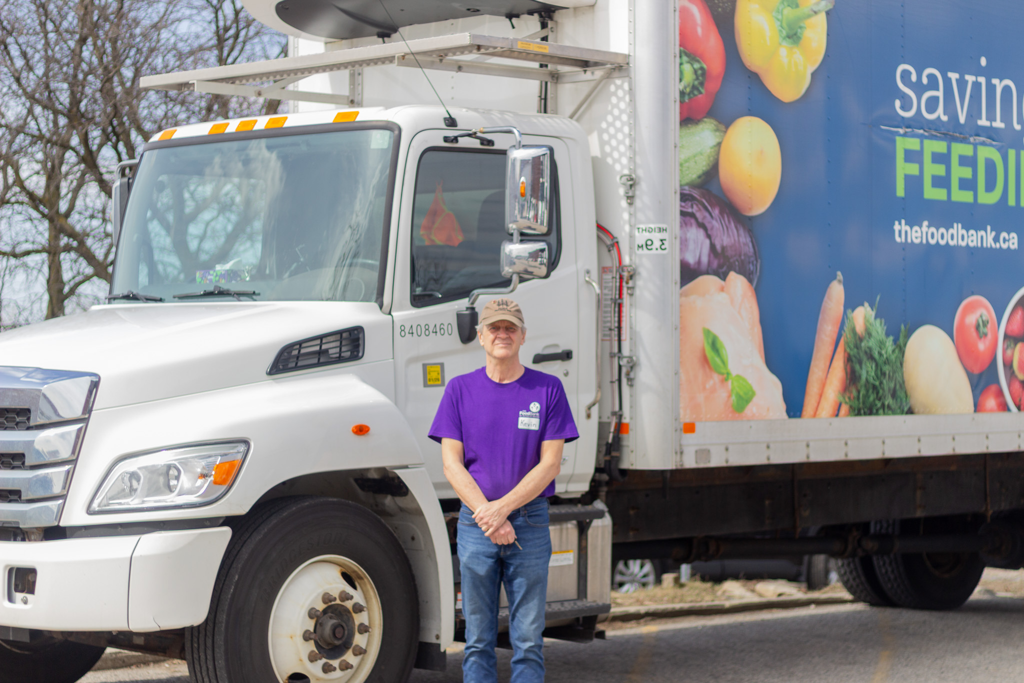 Volunteer driver in front of the Food Bank truck