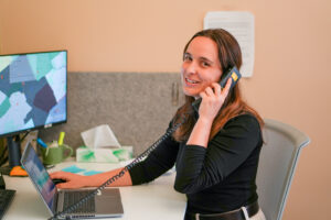 Rebecca Jeschke talking on the phone with a Network partner.