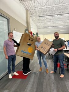 Phil the Food Drive Bag dropping off boxes at GovAI.