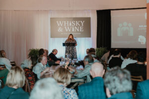 Speaker presenting at Whisky & Wine in the Warehouse
