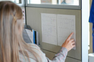 Emily pointing at a calendar of third-party fundraising events